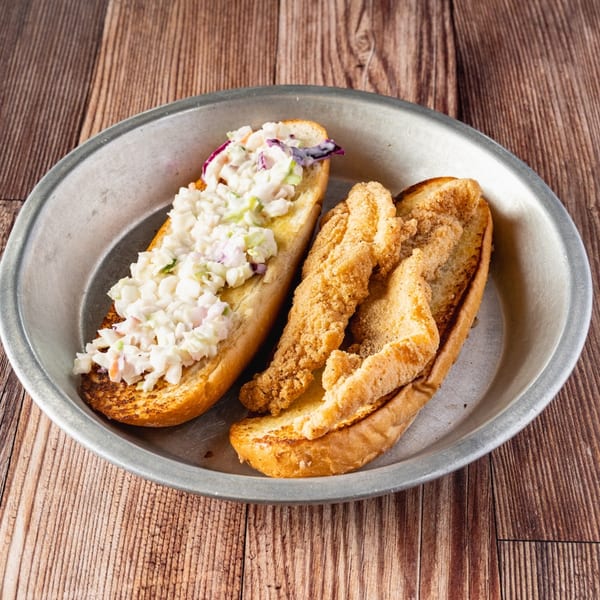 Bowie Barbeque's fried catfish po'boy with coleslaw on a metal plate.