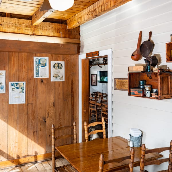 Rustic Bowie Barbeque interior with wooden walls, tables, chairs, and vintage decor.