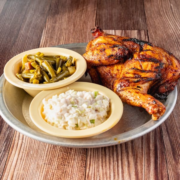 Bowie Barbeque's grilled chicken with green beans and coleslaw on a metal plate.