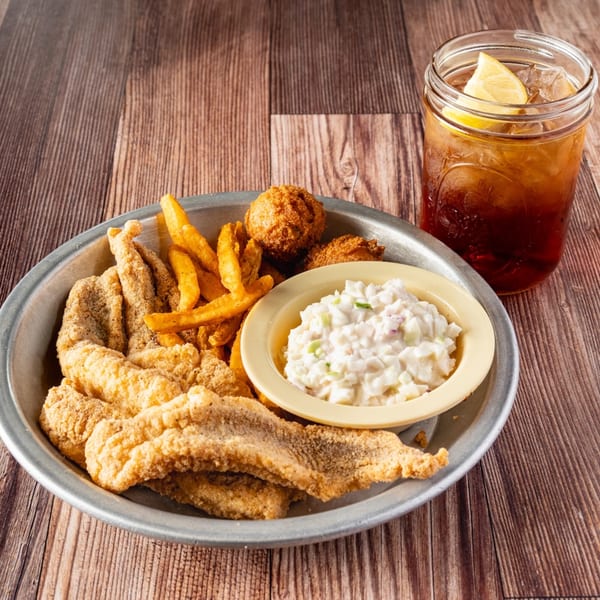 Bowie Barbeque's fried fish platter with fries, hush puppies, coleslaw, and iced tea.